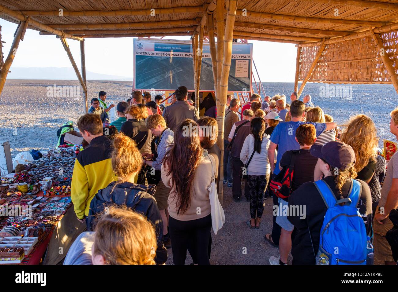 Mass tourism, overtourism, line of tourists waiting to go up Nazca Lines observation tower at sunset, lookout, Nazca, Peru Stock Photo