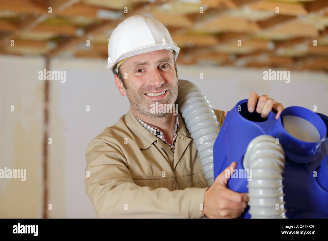 builder installer of ventilation with tools in hands Stock Photo