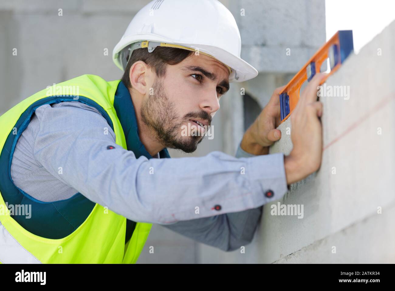 man builder measures the level of a wall Stock Photo