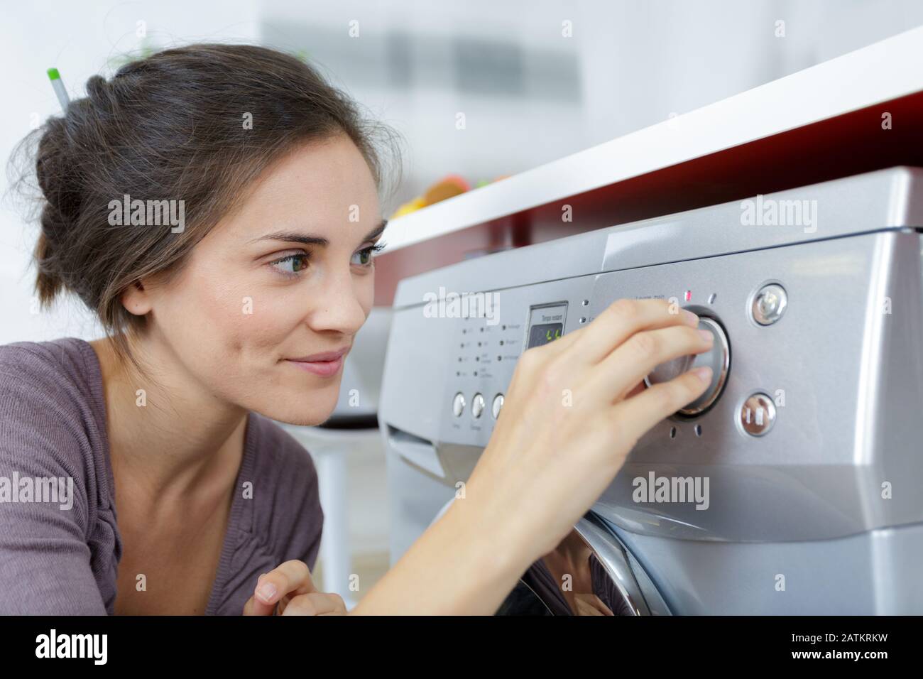 woman putting washing machine on Stock Photo Alamy