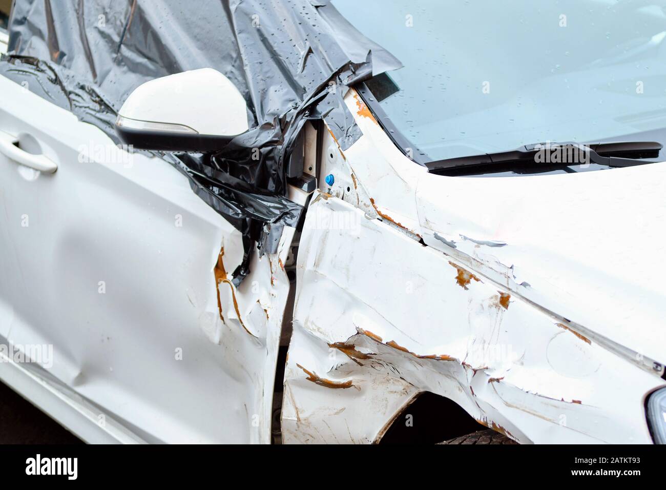 Cars after an accident with a damaged side mirror and door. Close up