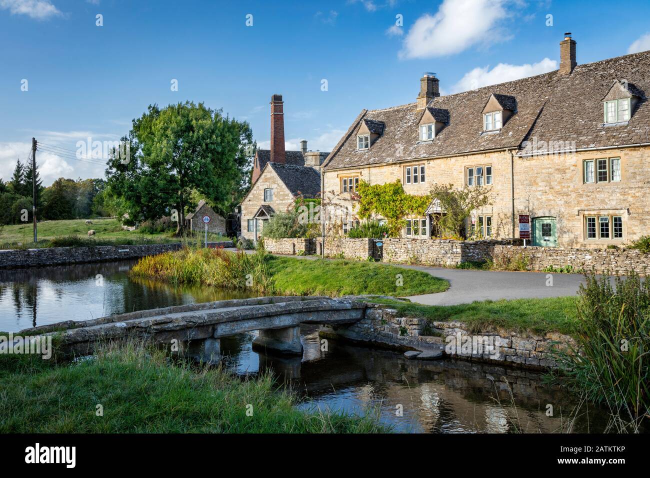 Connected cottage homes and the Old Mill along River Eye in Lower Slaughter, the Cotswolds, Gloucestershire, England, UK Stock Photo