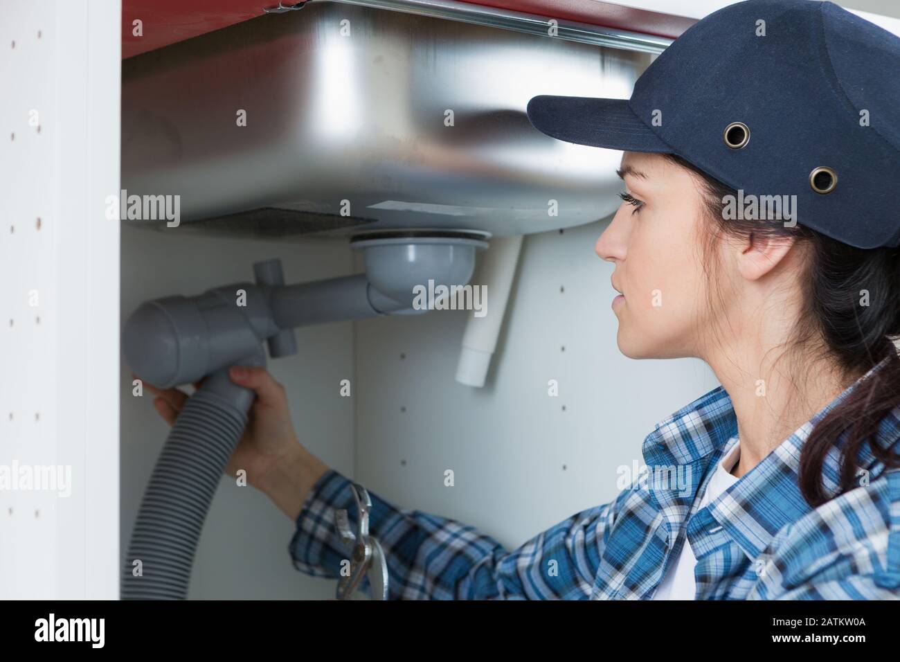 woman repairing her bathroom sink pipe Stock Photo Alamy