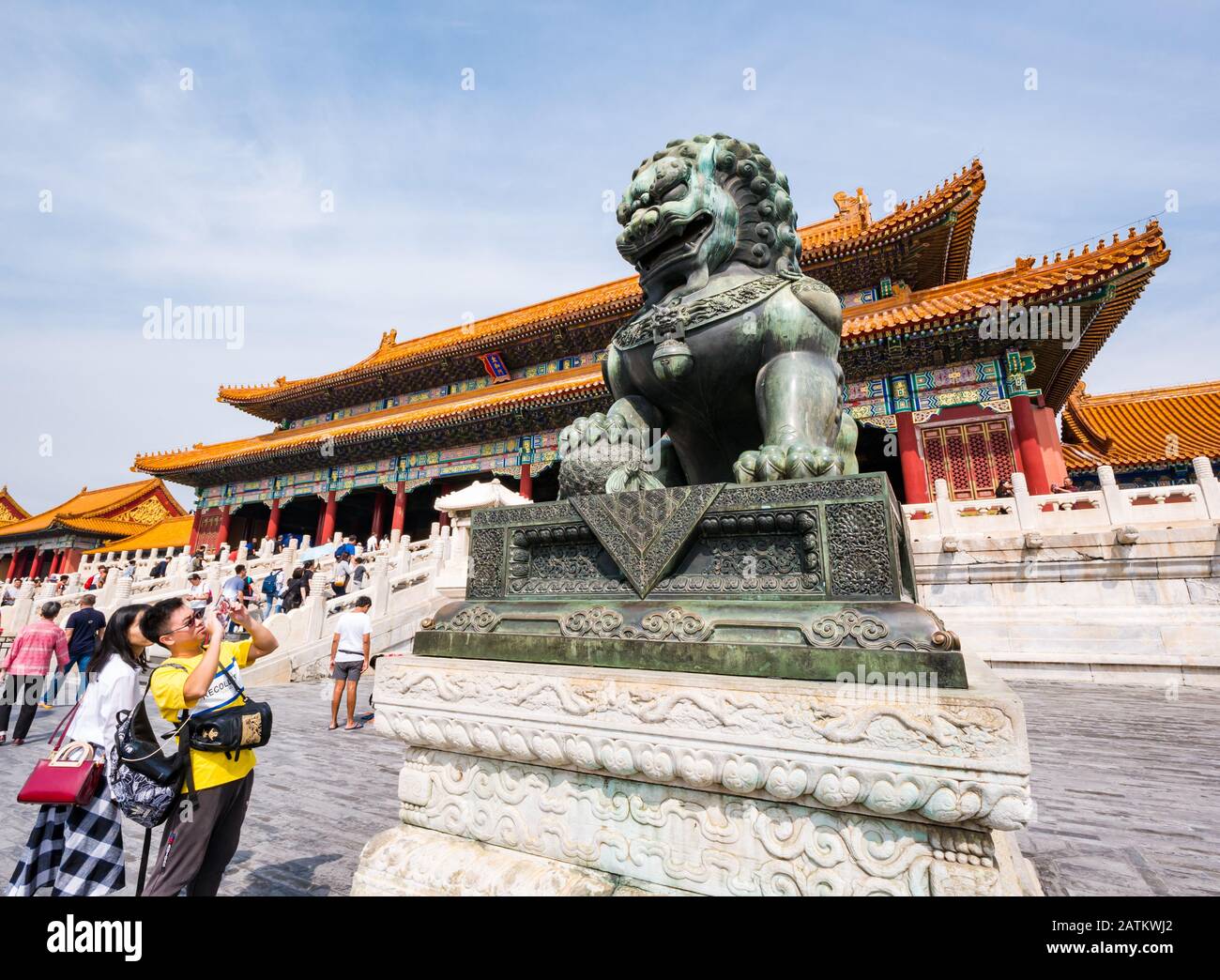 Tourists in front of Gate of Supreme Harmony (Taihemen) with bronze guardian lion, Outer Court, Forbidden City, Beijing, China Stock Photo