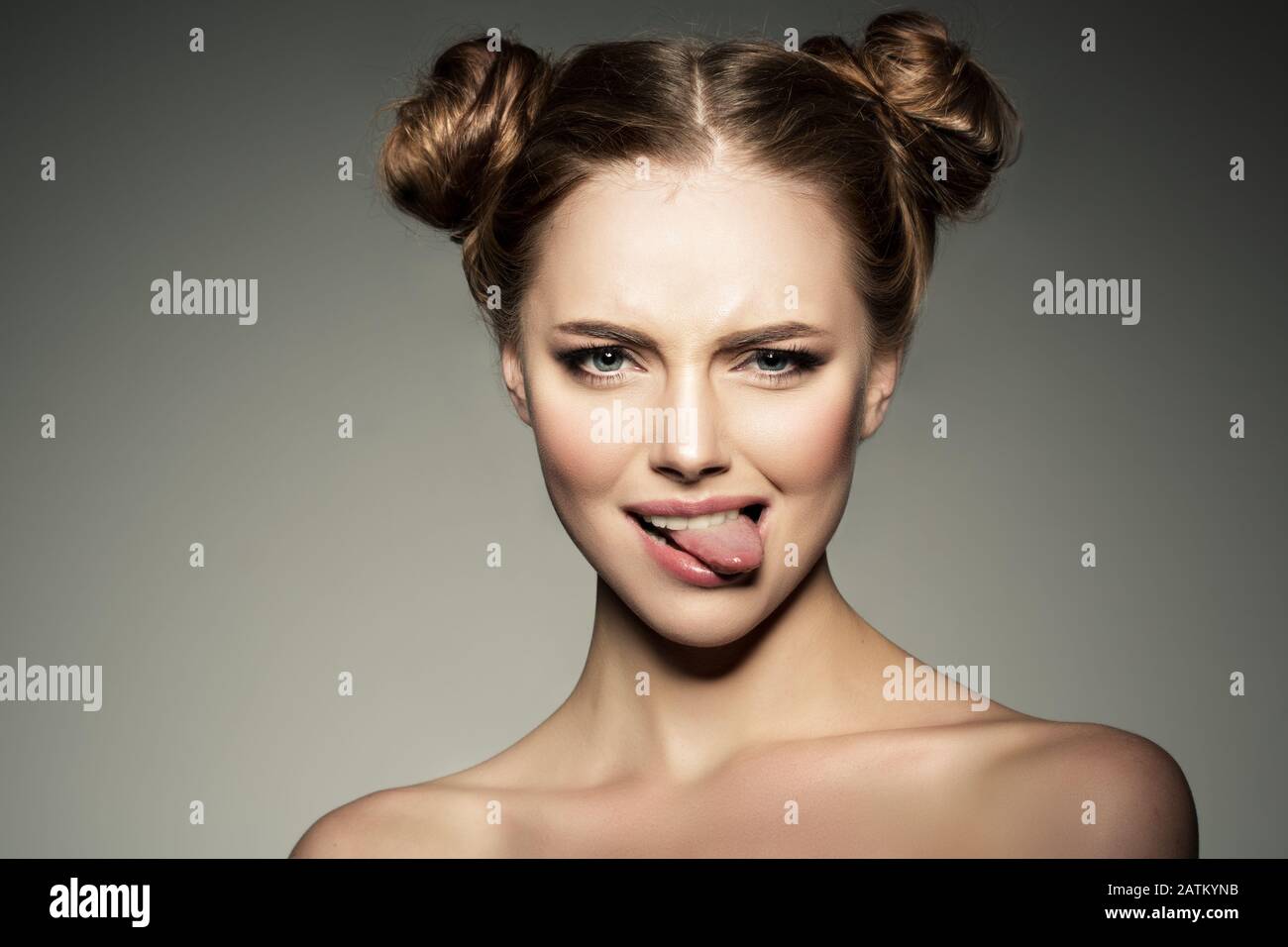 Emotional girl. Beautiful modern model shows tongue Positive woman hipster. Emotions on face. Stock Photo