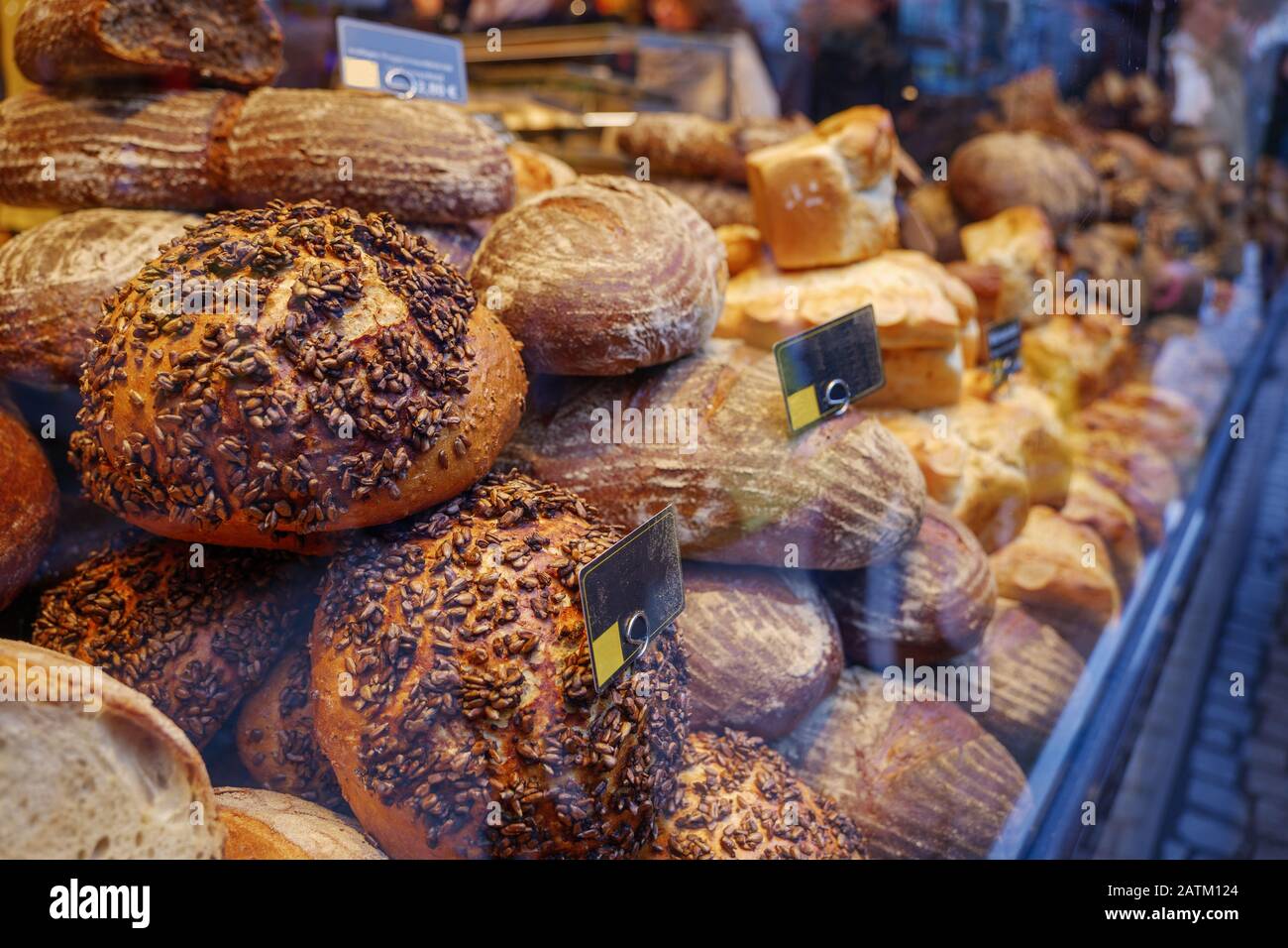 Store's display with heap and stack of wheat and rye breads with whole