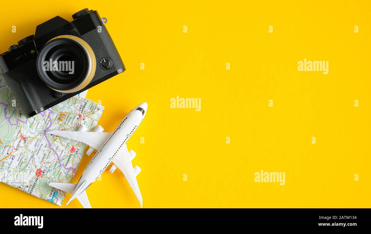 Travel planning concept. Flat lay traveler accessories on yellow background  with copy space. Top view plane, map, vintage camera. Travel agency banner  Stock Photo - Alamy