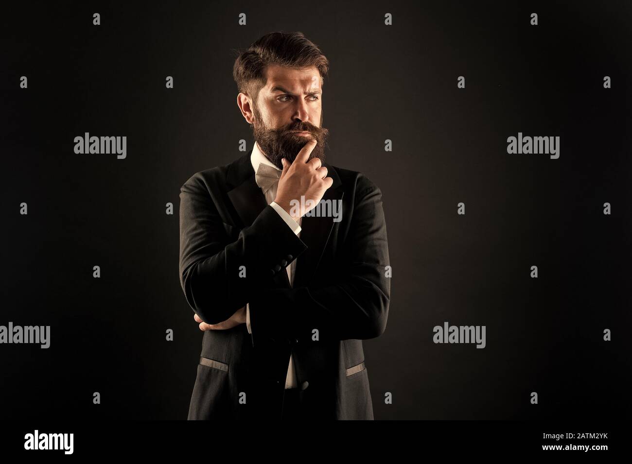 Official event dress code. Classic style. Menswear classic outfit. Bearded man with bow tie. Well dressed and scrupulously neat. Hipster formal suit tuxedo. Difference between vintage and classic. Stock Photo