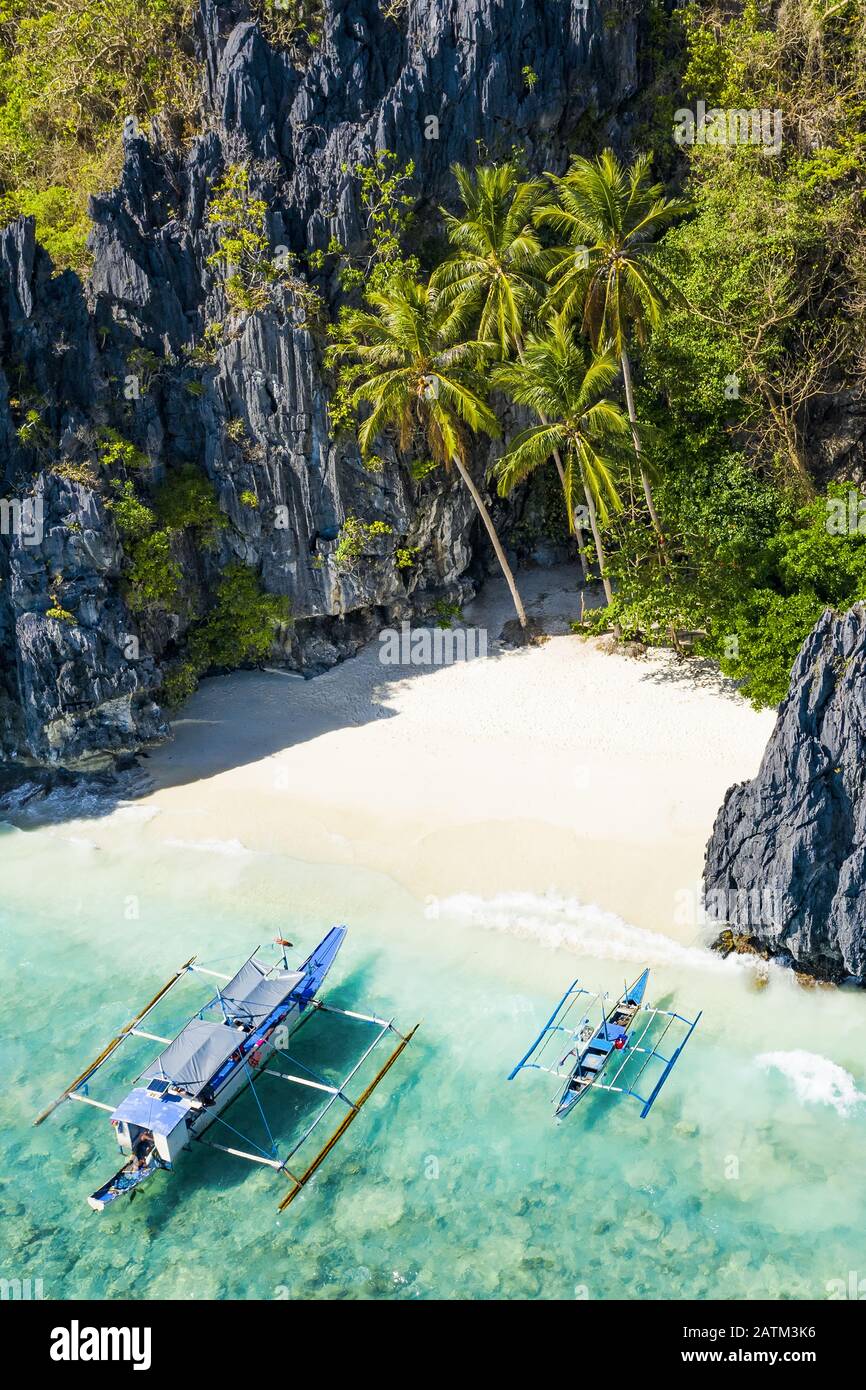 View from above, stunning aerial view the Entalula Beach, a white sand beach surrounded by rocky formations and bathed by a crystal clear sea. Stock Photo