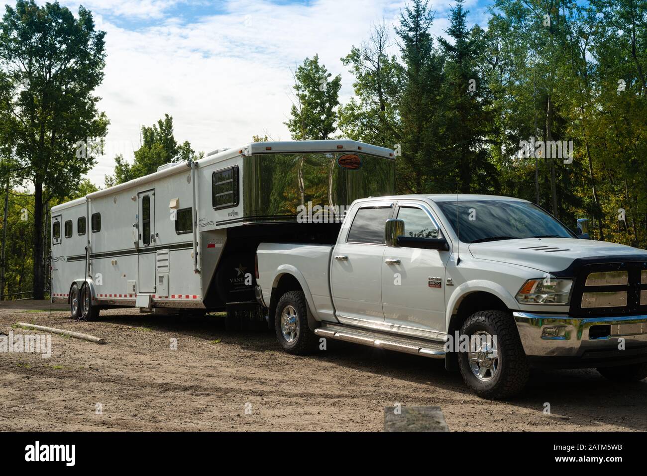 A white Dodge Ram pickup truck attached to an Equestrian trailer, parked in  the Chickakoo Lake Recreation Area in Alberta Canada Stock Photo - Alamy