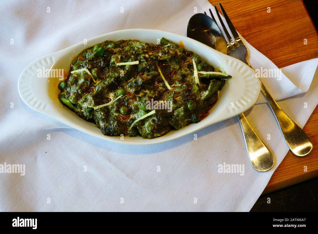 A spinach dish of saag paneer at an Indian restaurant Stock Photo Alamy