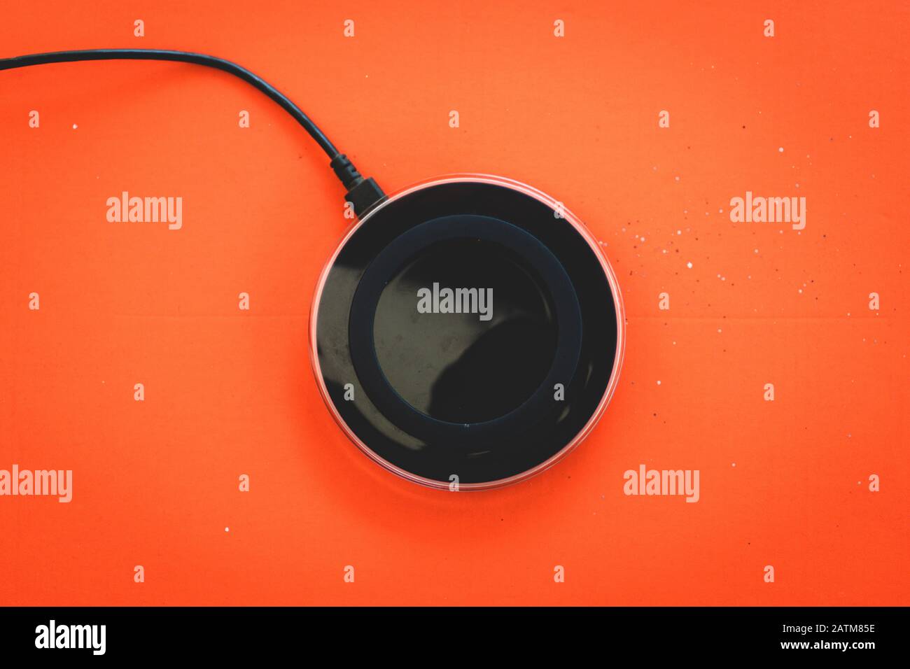 Wireless Charger orange background Top view Stock Photo
