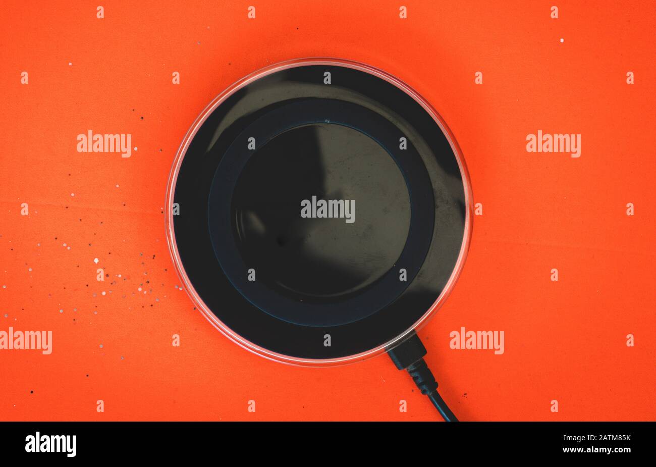 Wireless Charger orange background Top view Stock Photo