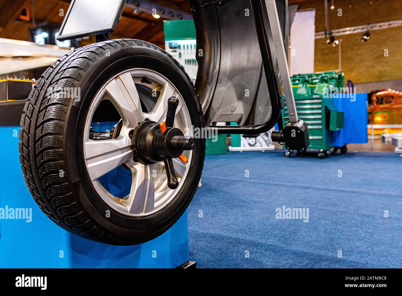 A car wheel on an automated car wheel balance machine in the garage
