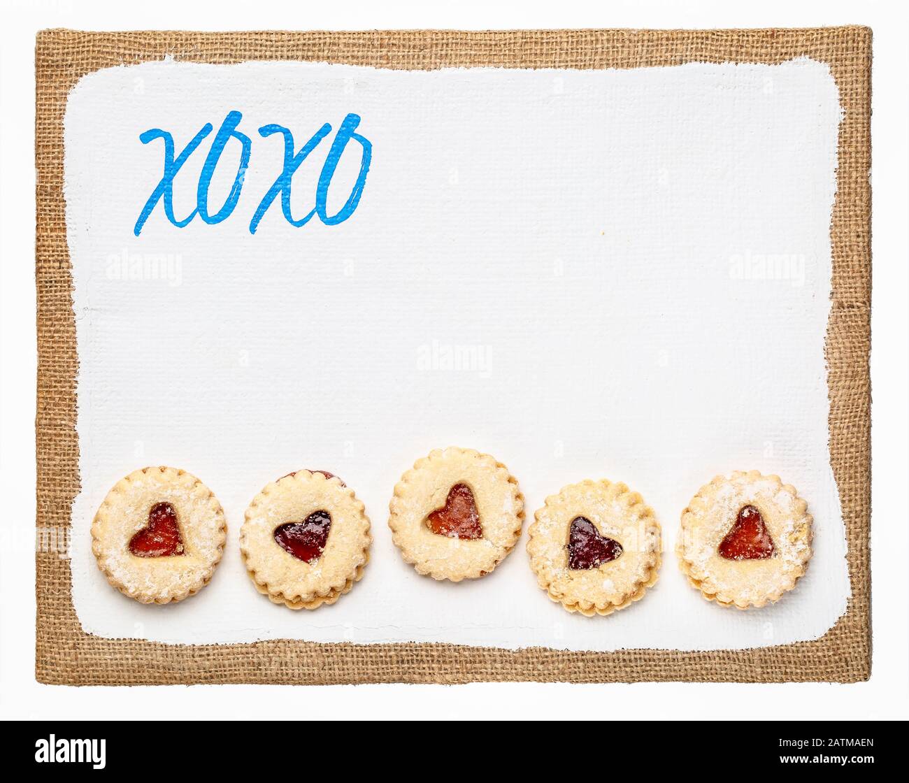 xoxo, hugs and kisses - expressing affection, sincerity, or deep friendship, handwriting on an art canvas with a row of heart cookies, love and Valent Stock Photo