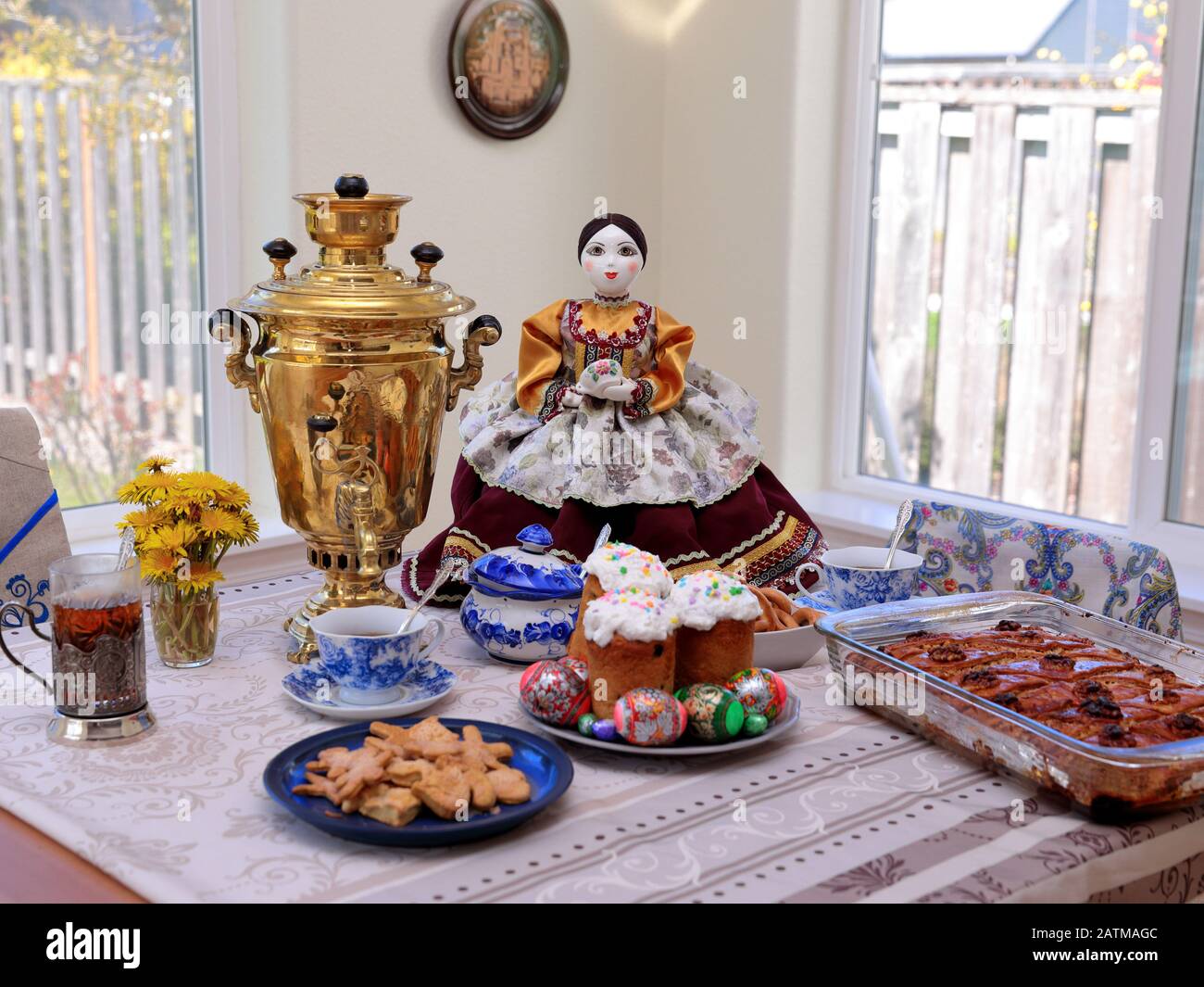 Hillsboro, OR  USA - 15 April 2017: Setup for Russian tea ceremony including samovar, Easter cakes, decorated eggs, and pakhlava. A decorative tea coz Stock Photo