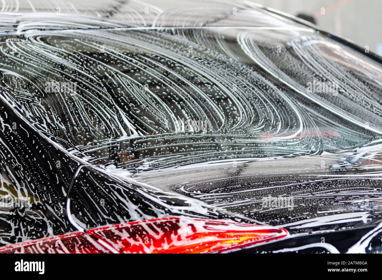 Cleaning black cars. Wash the car at the car wash station with foam bubbles Stock Photo Alamy
