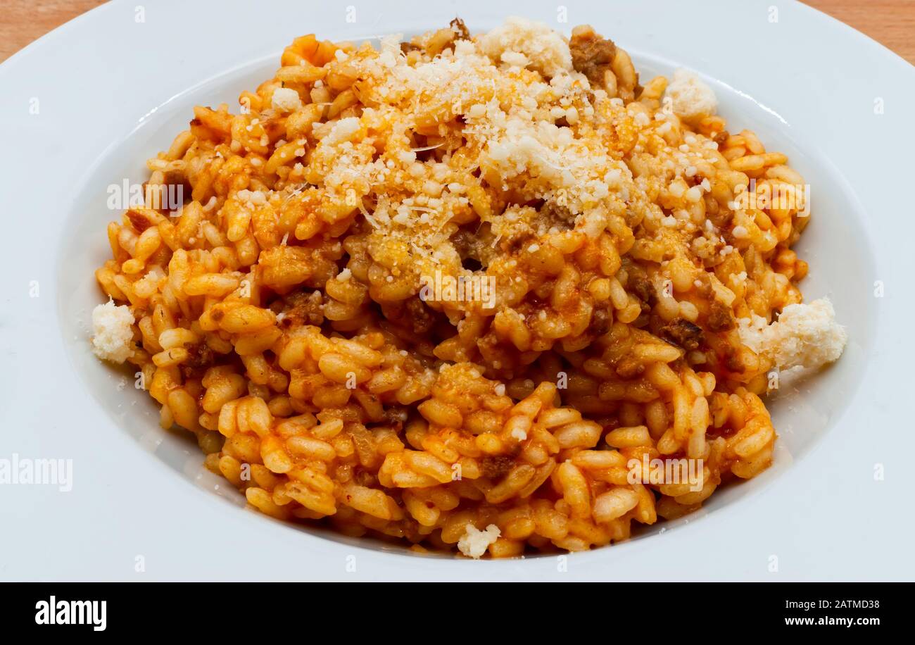 Traditional italian risotto with bolognese ragu and parmigiano reggiano cheese Stock Photo