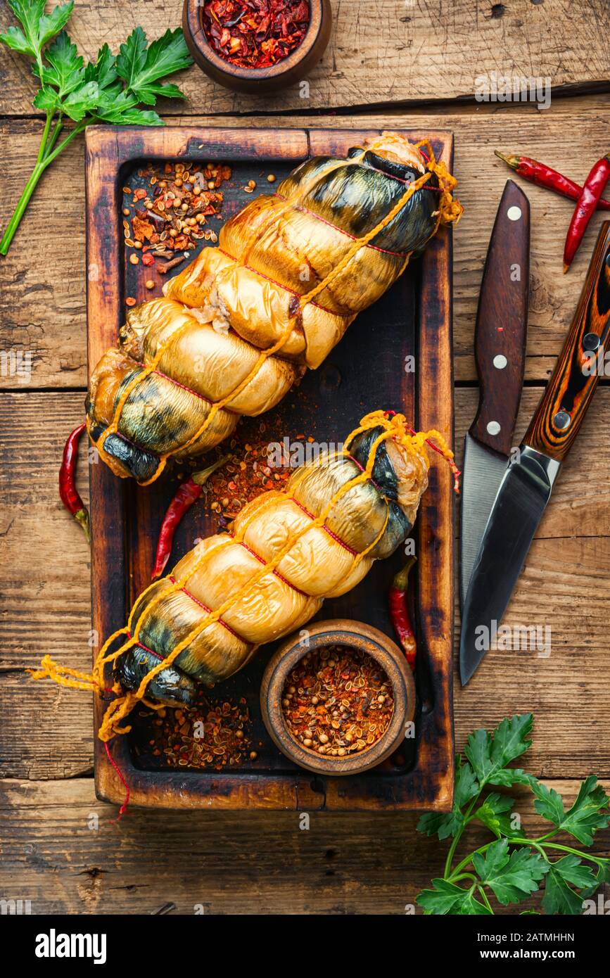 Appetizing fish roll made from smoked mackerel on wooden table Stock Photo