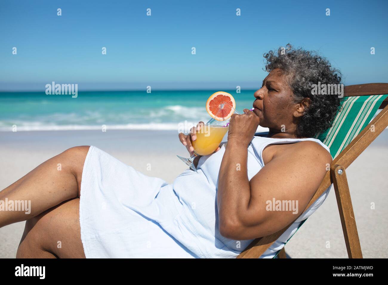 Old woman relaxing at the beach Stock Photo - Alamy