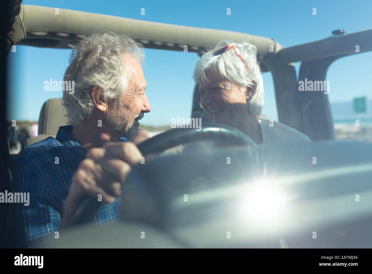 Old couple with a car at the beach Stock Photo