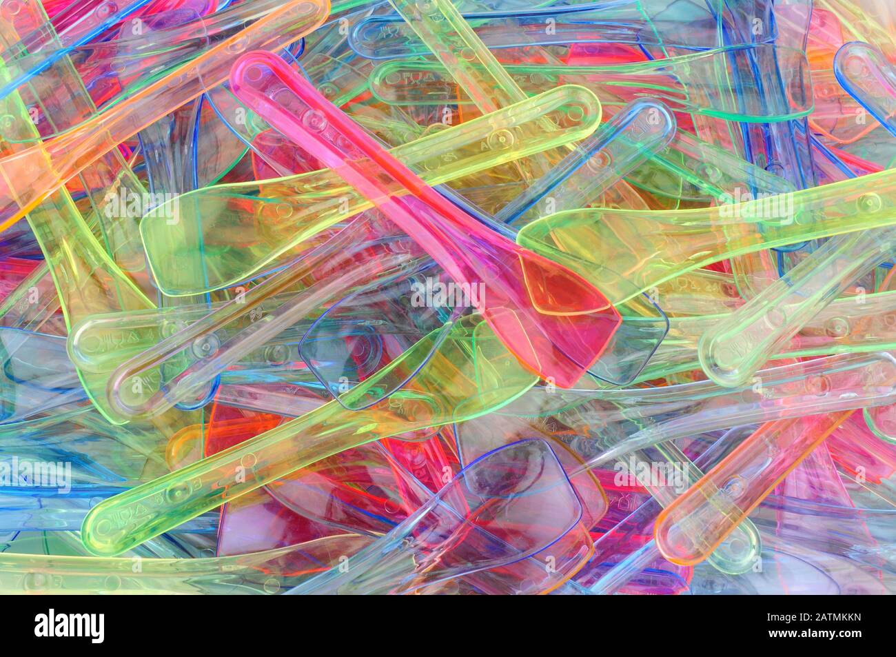 Coloured plastic ice cream spoons background Stock Photo - Alamy
