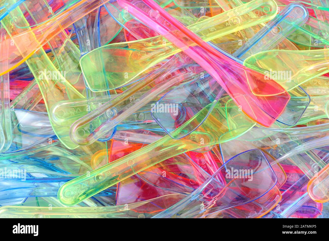 Coloured plastic ice cream spoons background Stock Photo - Alamy