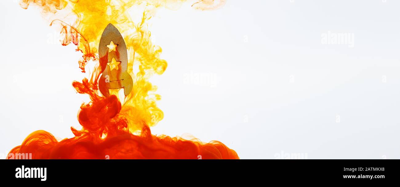 Rocket is launching into space with yellow and orange clouds on white ...
