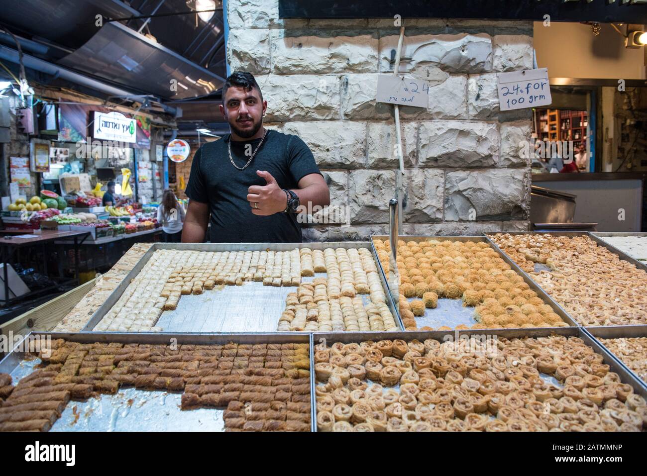 JERUSALEM, ISRAEL - MAY 15, 2018: Jewish vendor selling oriental delights and sweets in Machane Yehuda market in Jerusalem Stock Photo