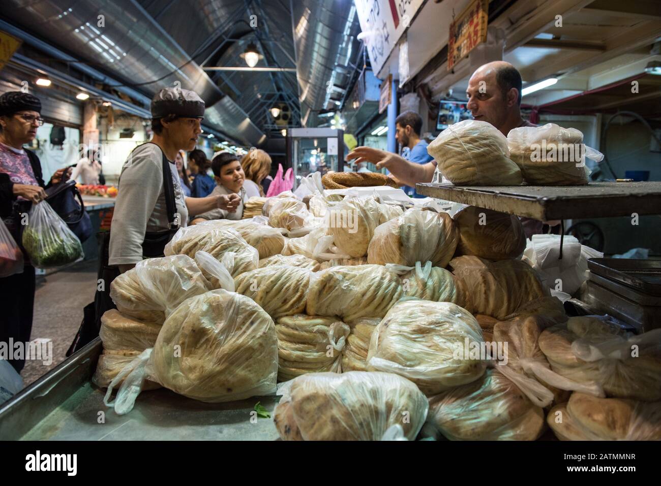 JERUSALEM, ISRAEL - MAY 15, 2016: Tourists and local Jewish people buying bread at the local market of the Holy city, the Machane Yehuda Stock Photo