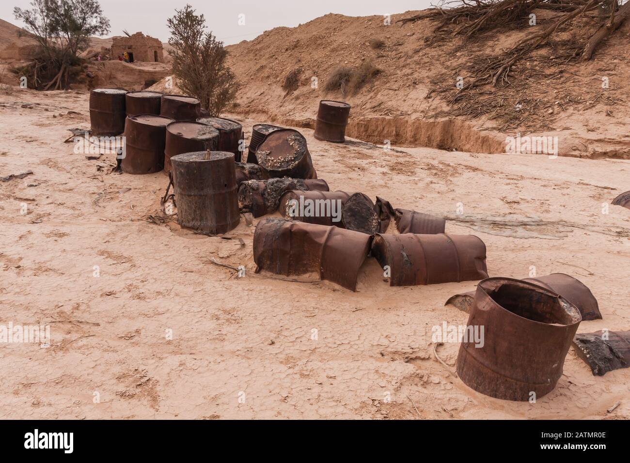 Abandoned empty diesel fuel barrels in the desert of Khafs Daghrah, Riyadh Province, Saudi Arabia Stock Photo