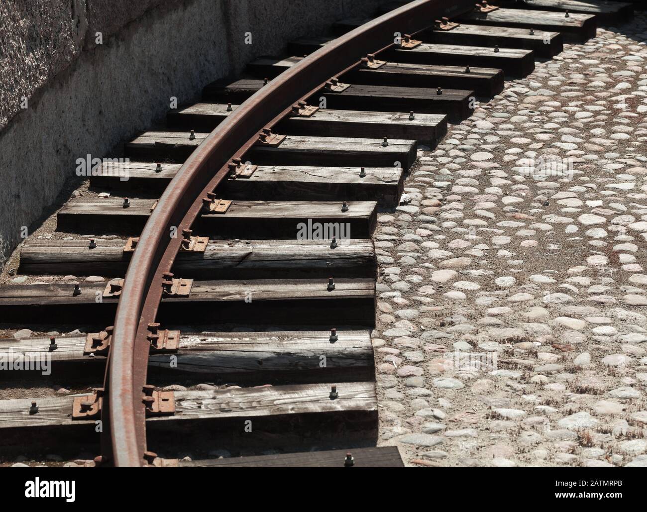 Grungy turning rail on dark wooden sleepers, vintage reversal circle for steam locomotives Stock Photo