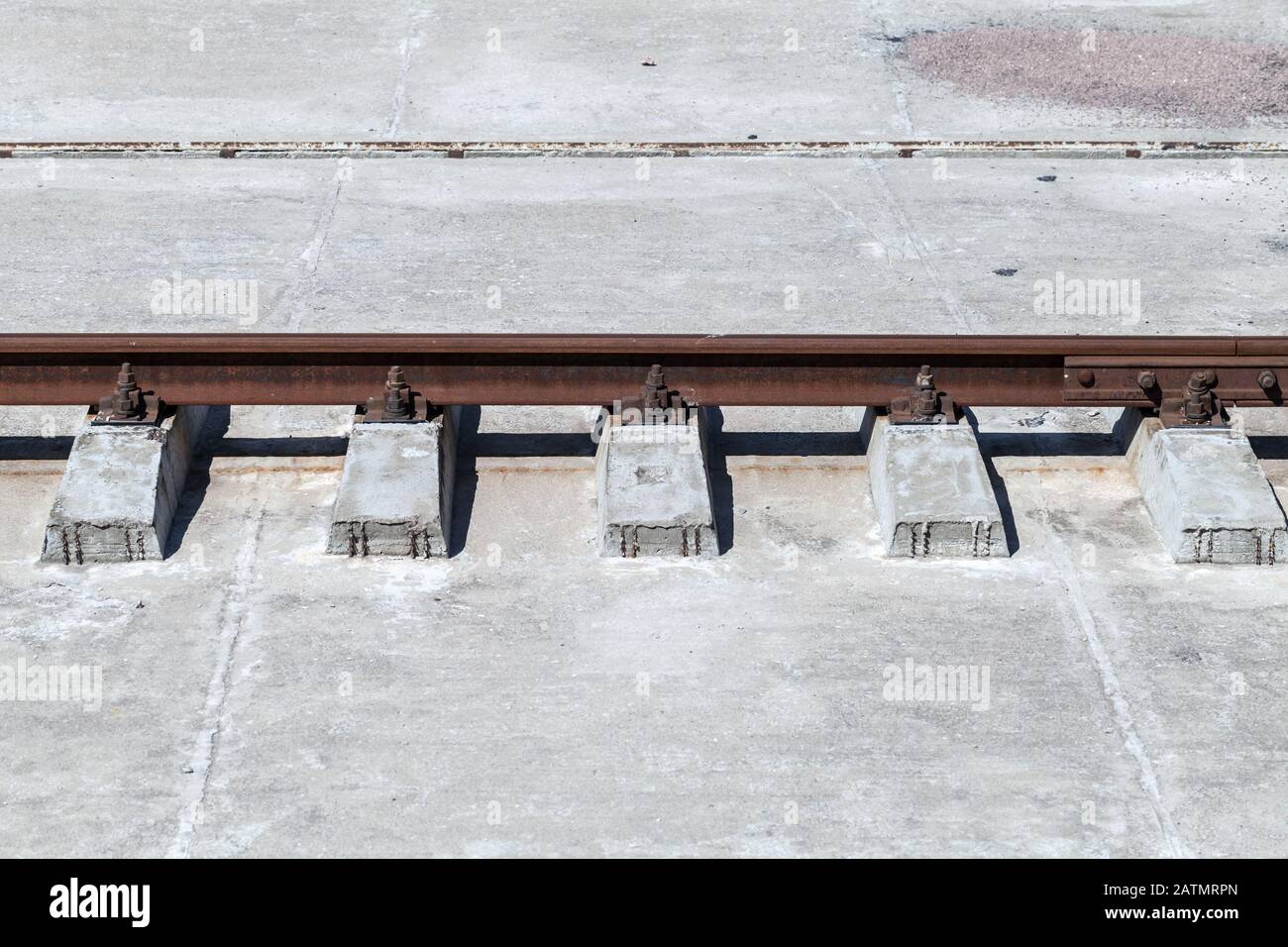 Rusty rail on concrete sleepers, side view Stock Photo