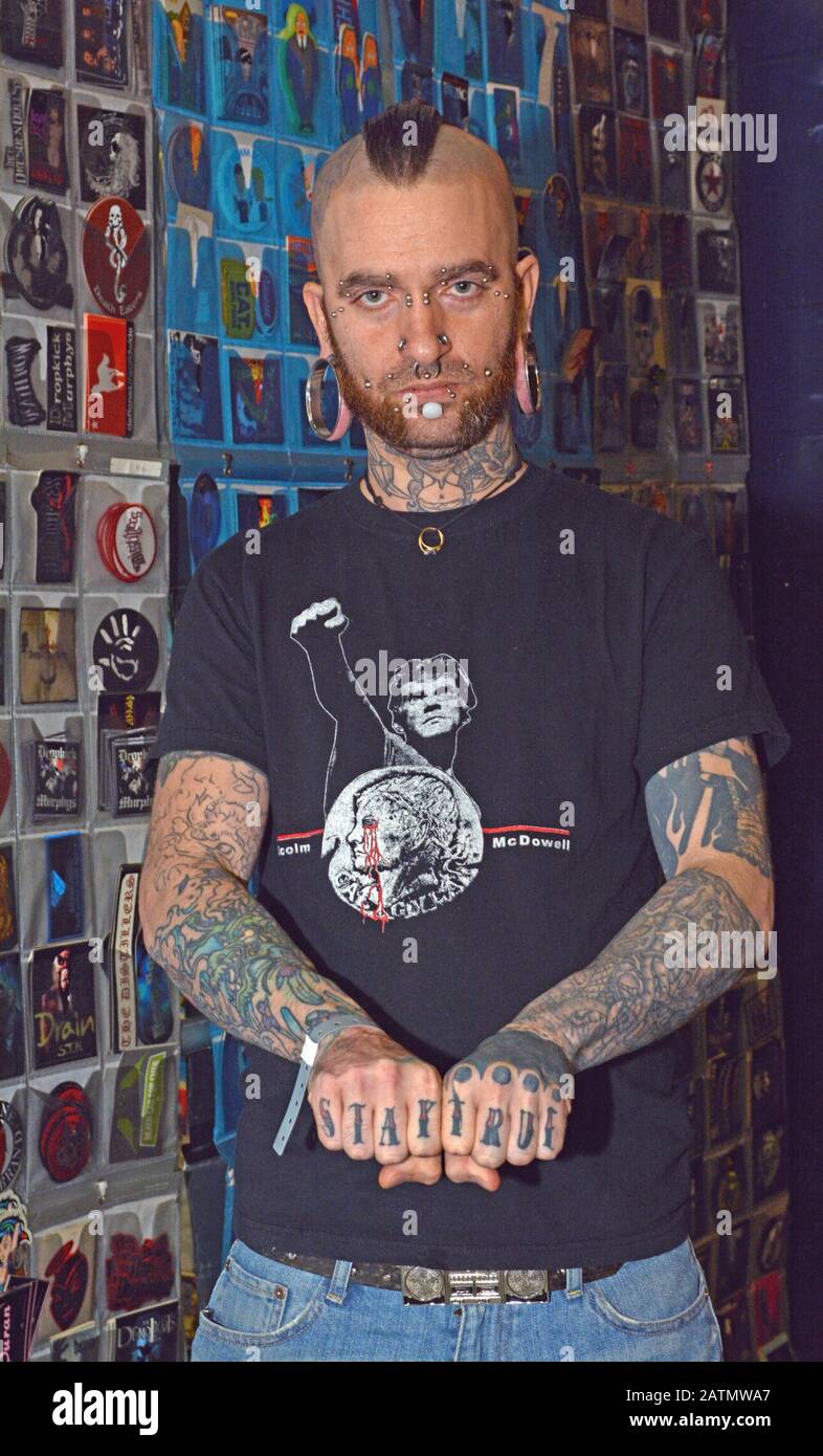 Portrait of a man with a mohawk covered in tattoos. At a tattoo convention at the Nassau Coliseum in Long Island, New York Stock Photo