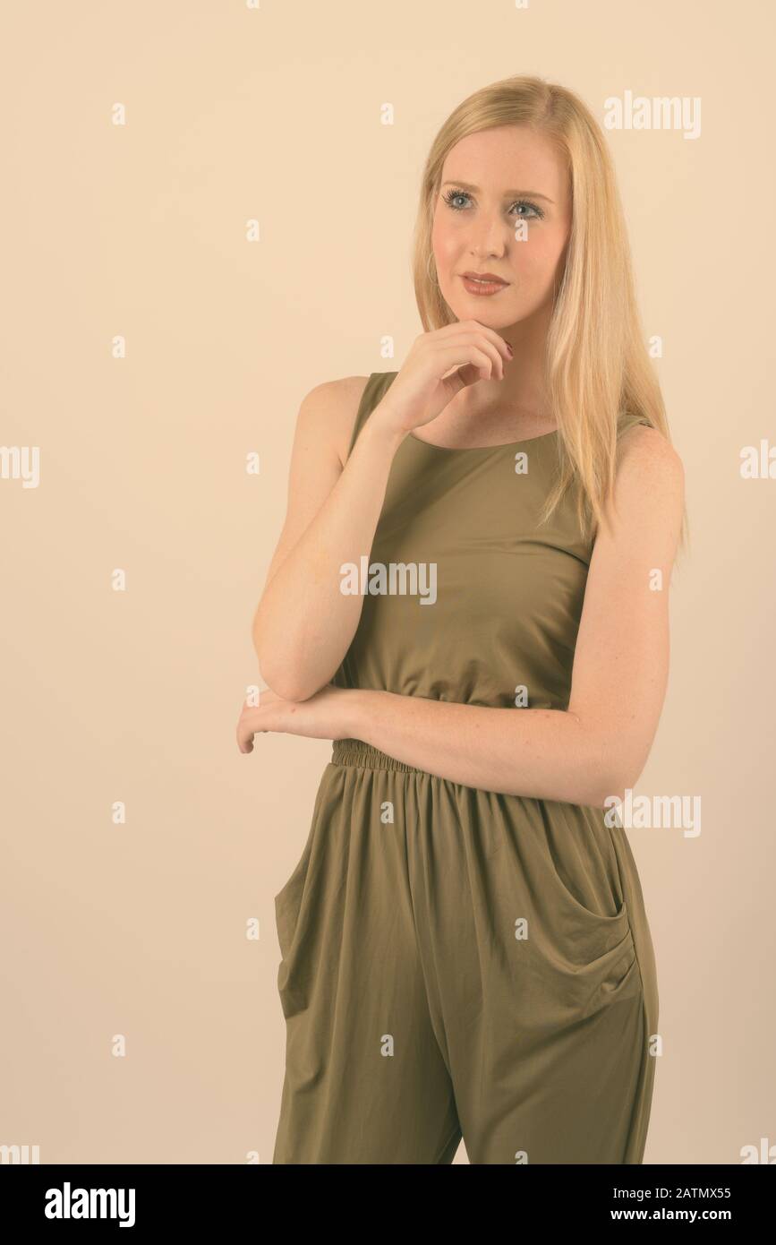 Young beautiful woman with blond hair against white background Stock Photo