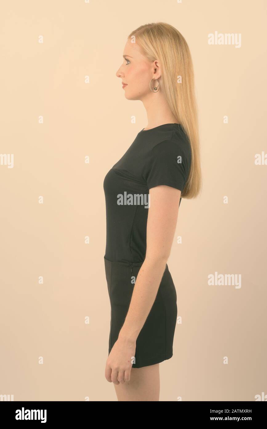 Young beautiful woman with blond hair against white background Stock Photo