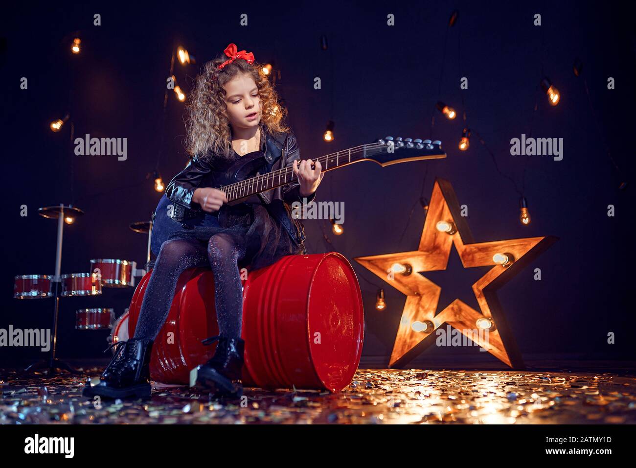 Young attractive rock girl playing the electric guitar Stock Photo - Alamy