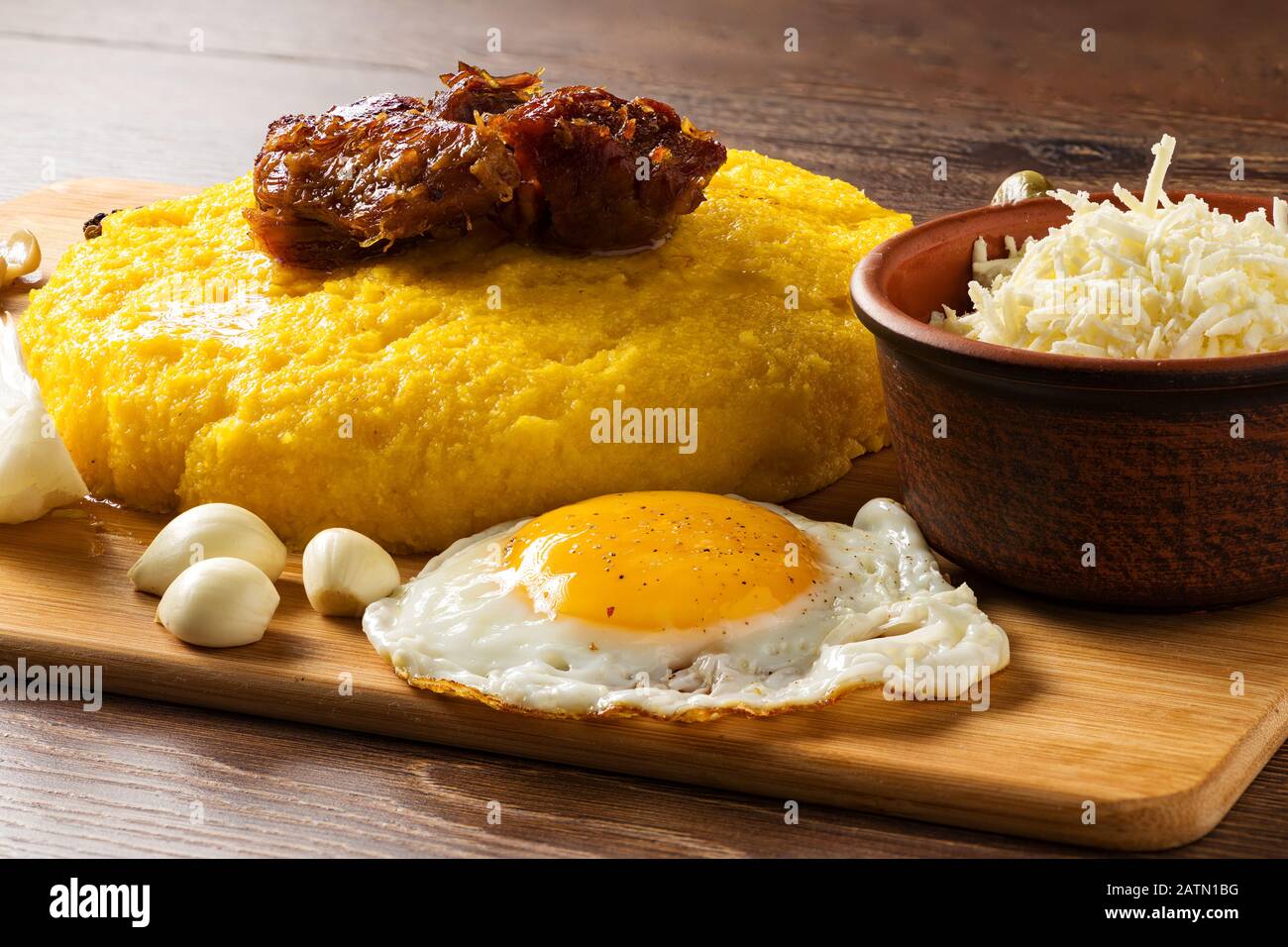 hominy egg meat and garlic on a wooden plateau Stock Photo