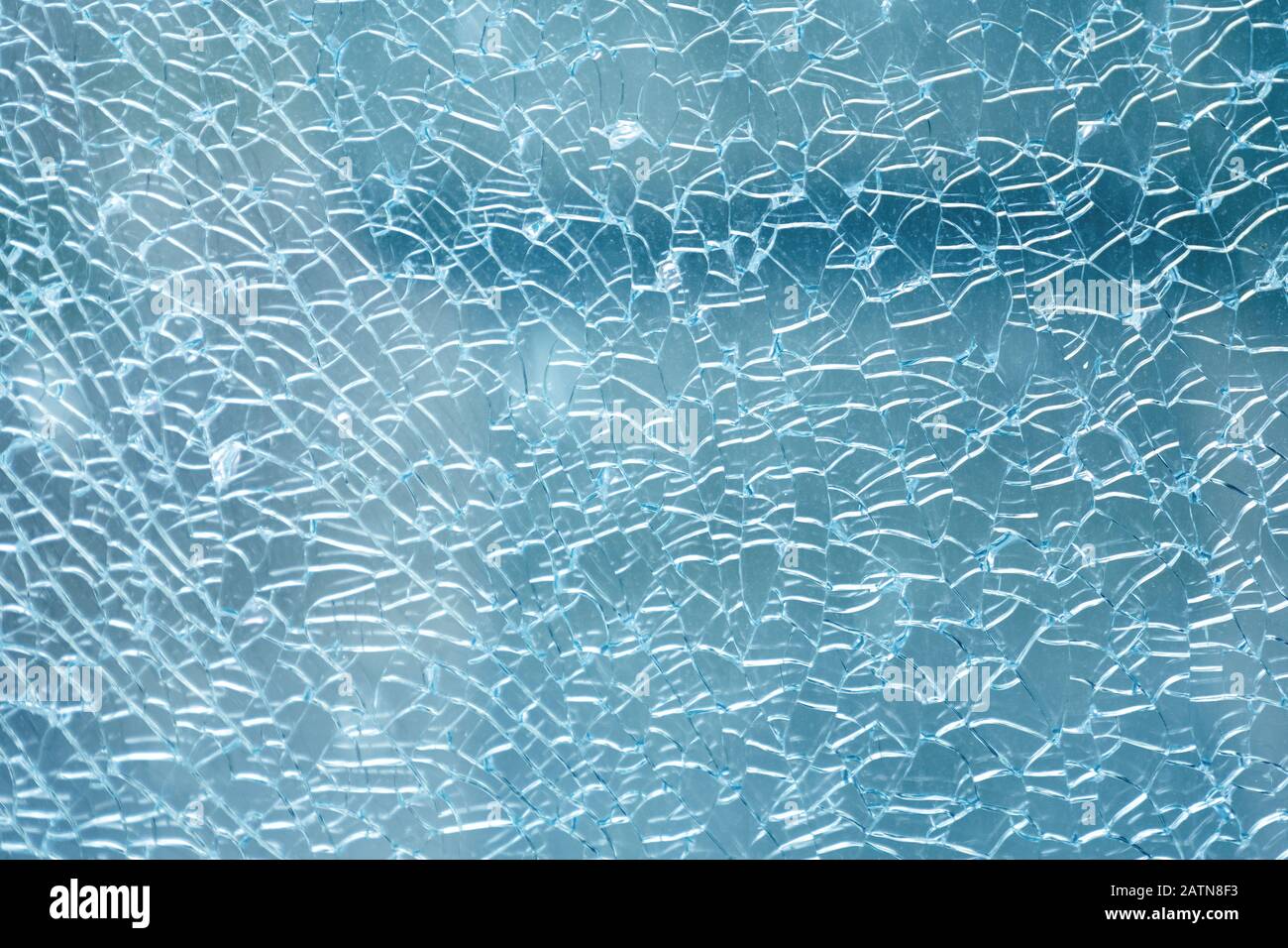 Cracked and damaged glass window for texture and background Stock Photo