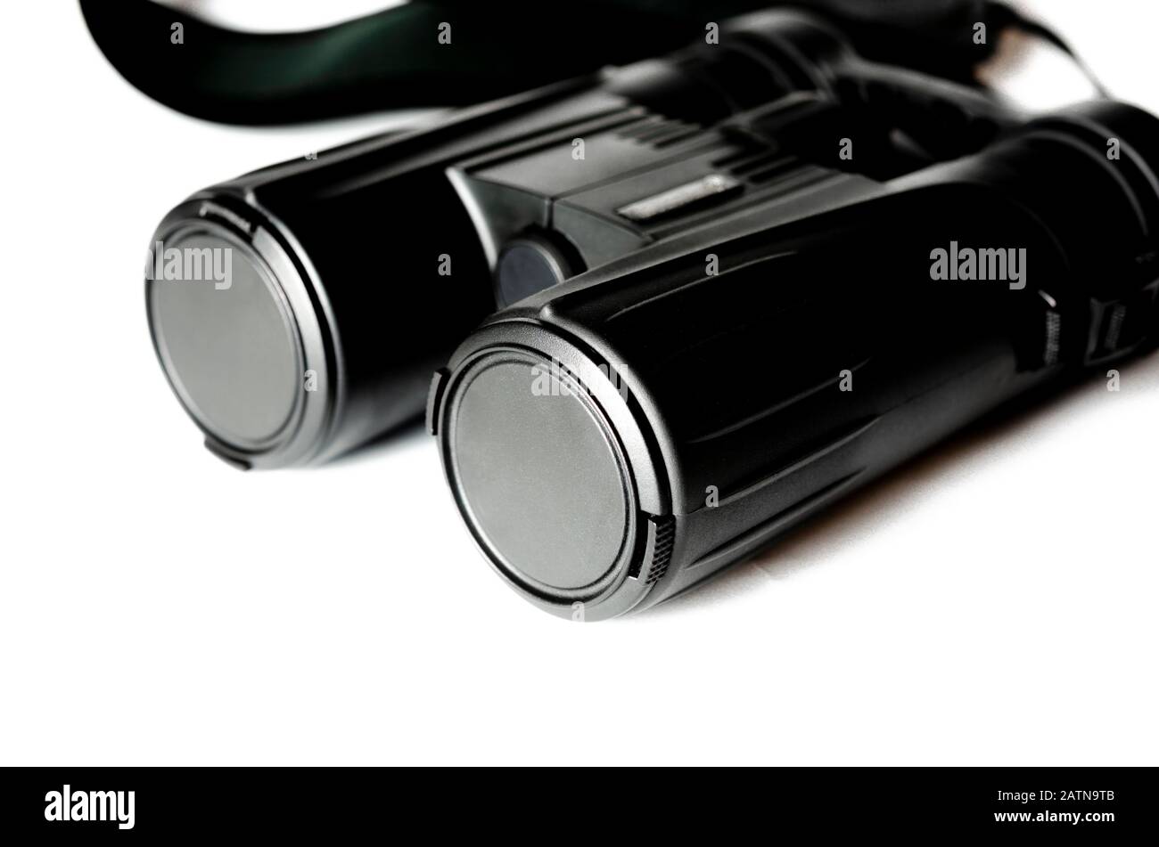 Black binoculars with closed lenses rests on a white background Stock Photo
