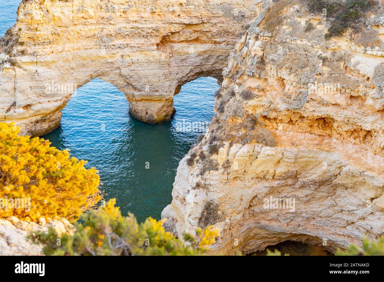 Beautiful view of Praia da Marinha. Rocks, cliff and green plants in ...