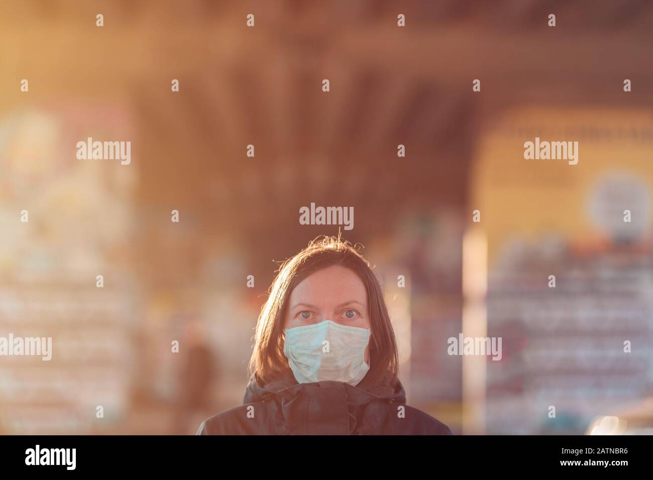 Woman with face protective mask standing on the street, protection from epidemics respiratory virus infections Stock Photo