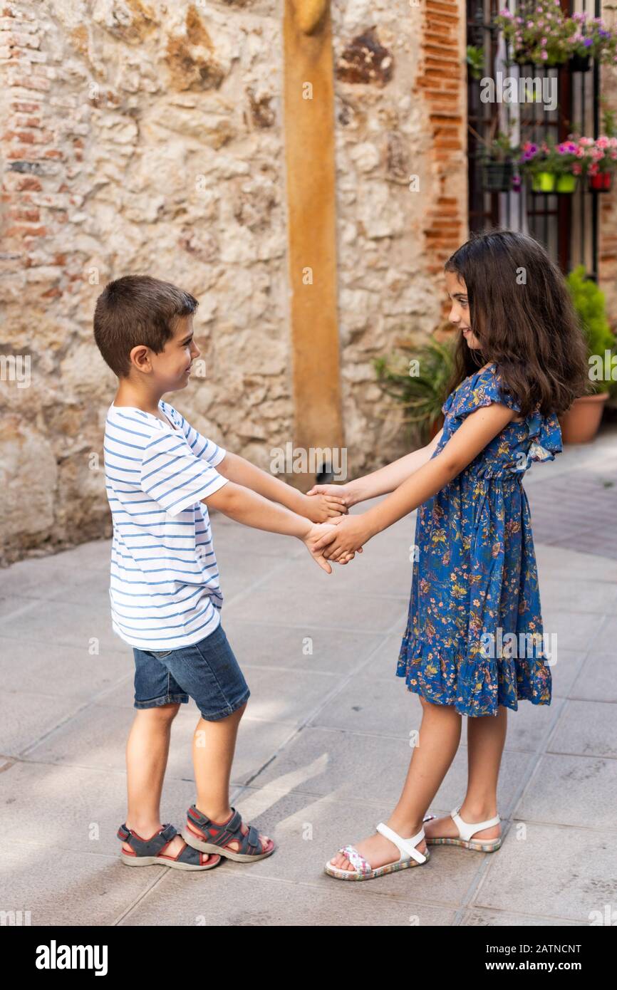 Two children holding hands on a spring day Stock Photo