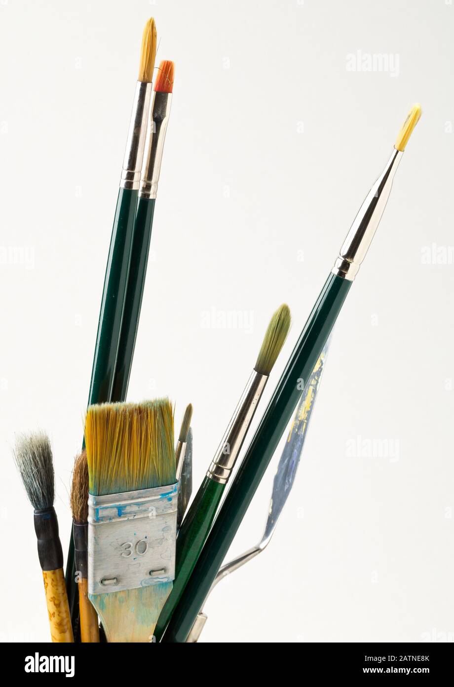 Artistic art supply utensils with paintbrushes isolated on white background with selective focus Stock Photo