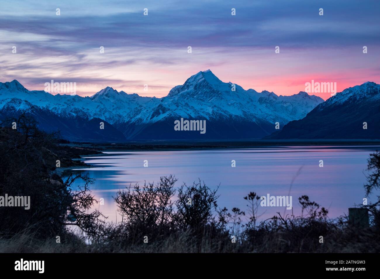 Beautiful colorful sunrise over glacial Lake Pukaki and Mount Cook from near Twizel, winter, New Zealand Stock Photo