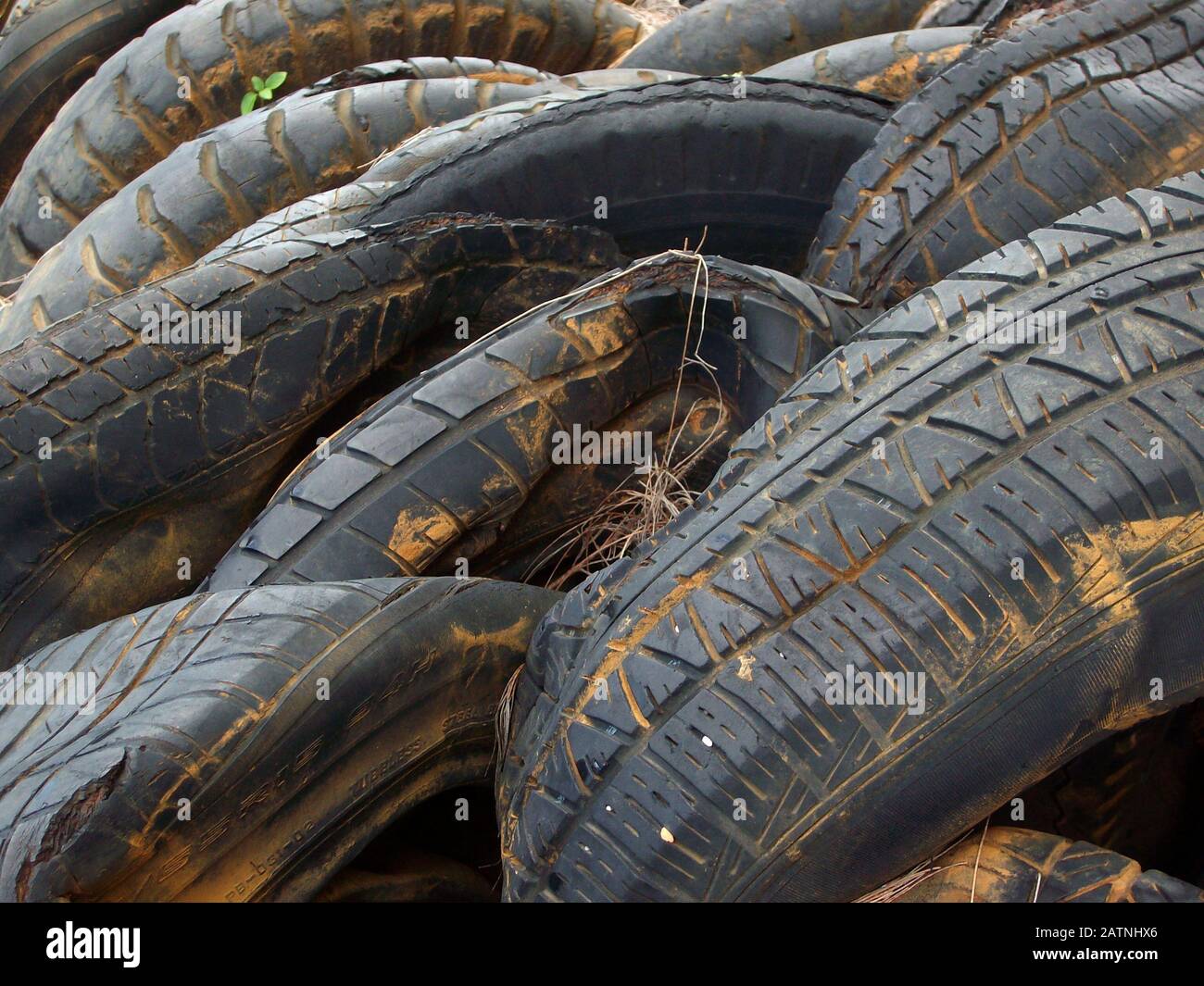 Close up of a pile of old tires squeezed together at a dump site Stock Photo