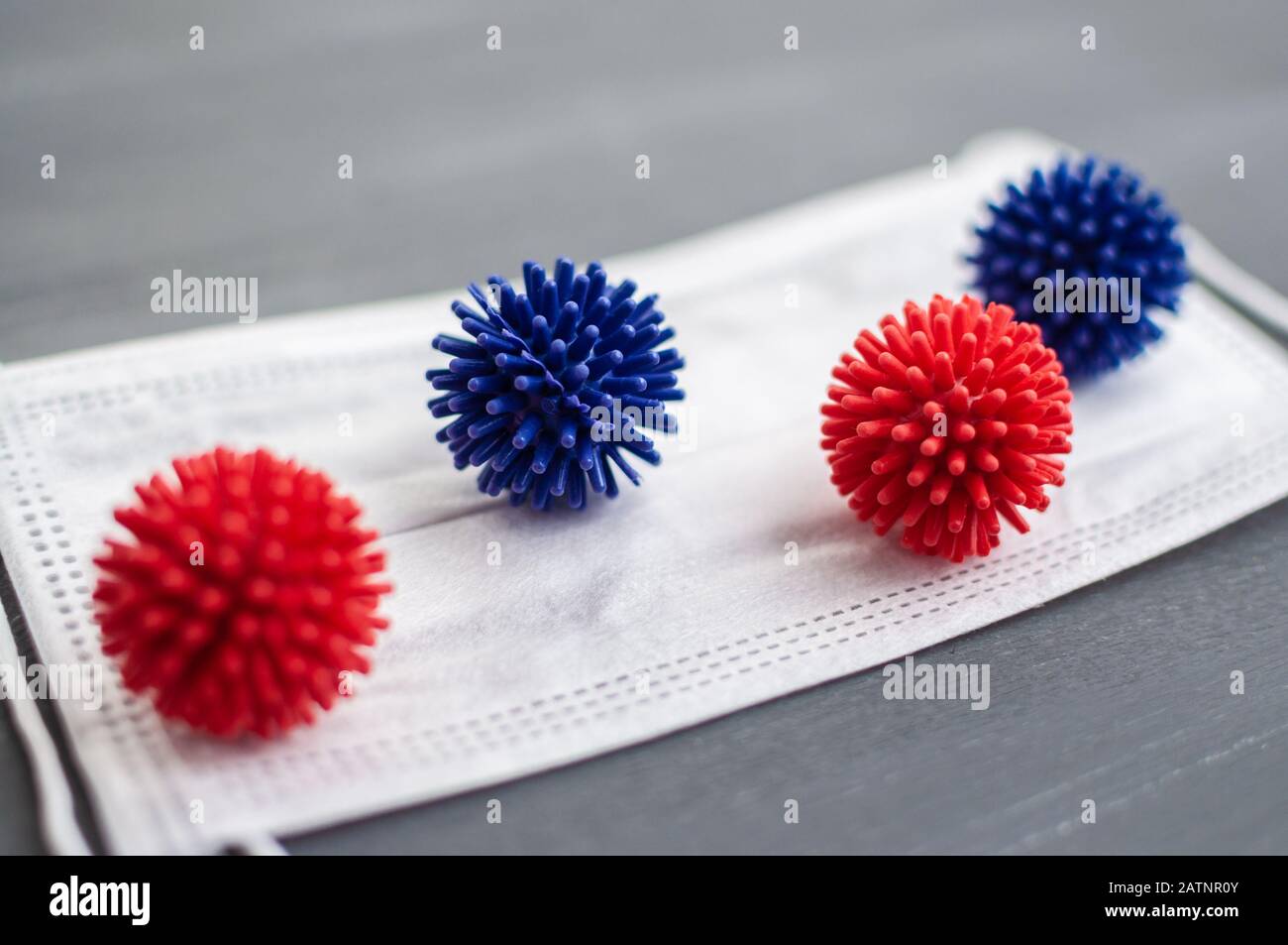 Abstract coronavirus strain model from Wuhan, China. Outbreak Respiratory syndrome and Novel coronavirus 2019-nCoV with free space on grey background. Stock Photo