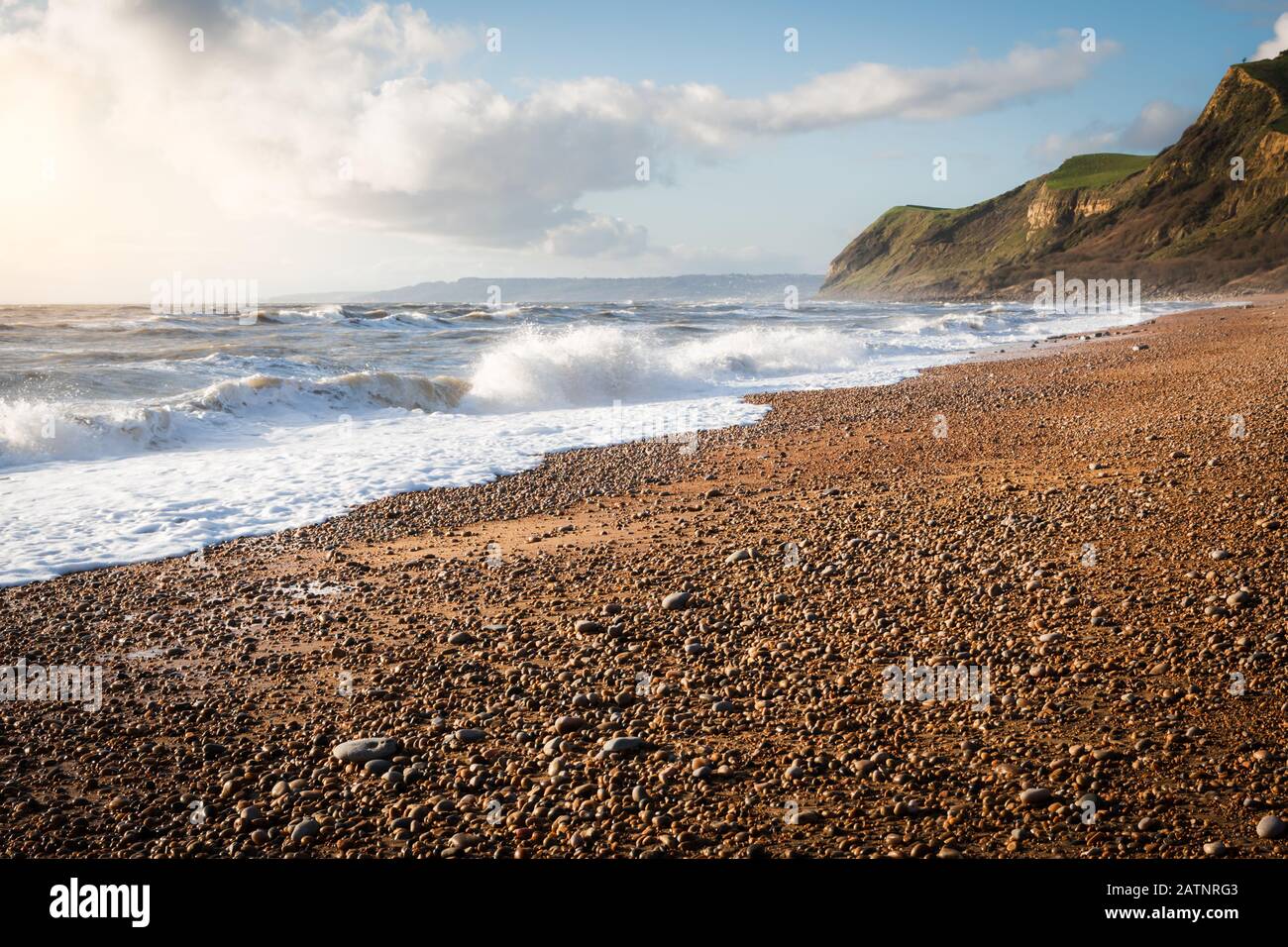 Waves breaking on the beach at Eype in Dorset Stock Photo