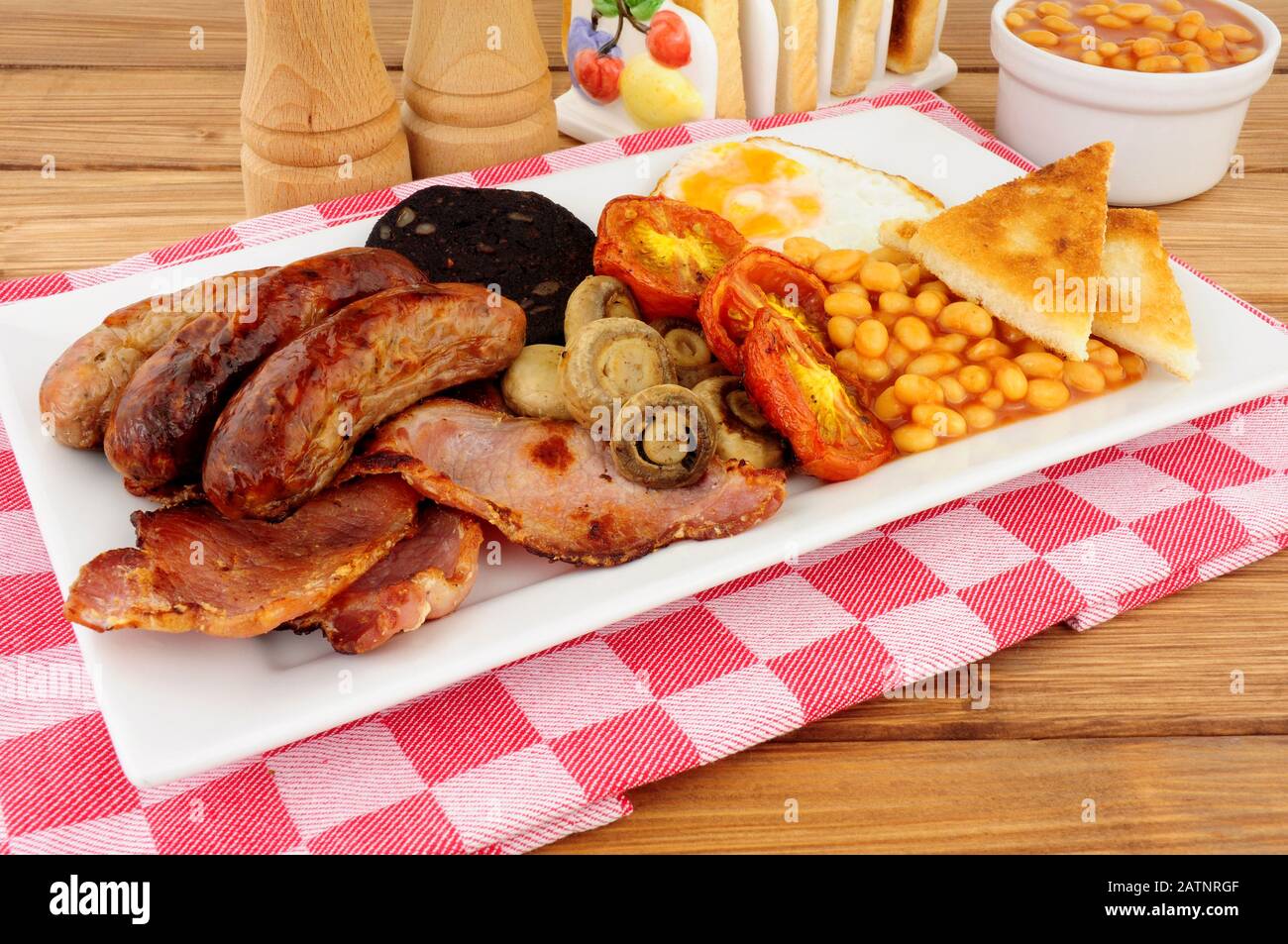 Traditional full English breakfast with sausages and bacon Stock Photo ...