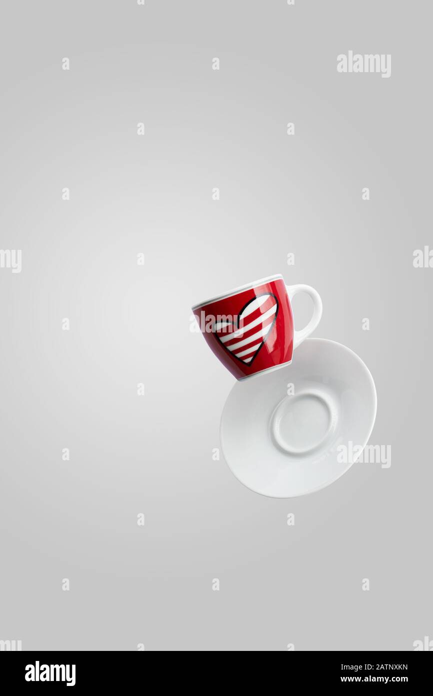 Red With Heart Cup Of Coffee Levitation In The Air On Grey Background